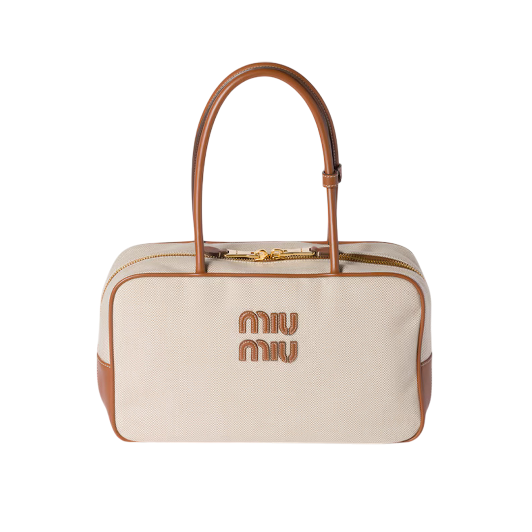canvas and leather bow bag featuring brandy-colored leather trimming